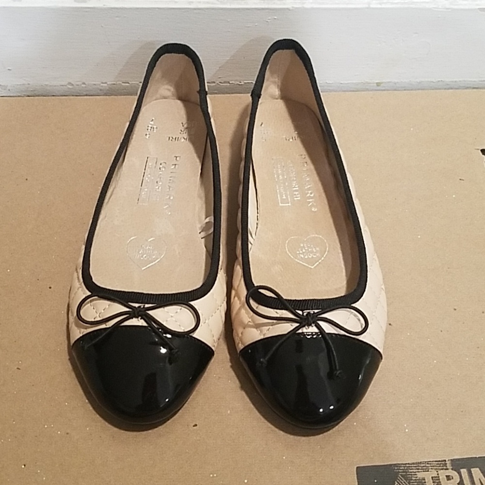 Light pink and black tipped flats